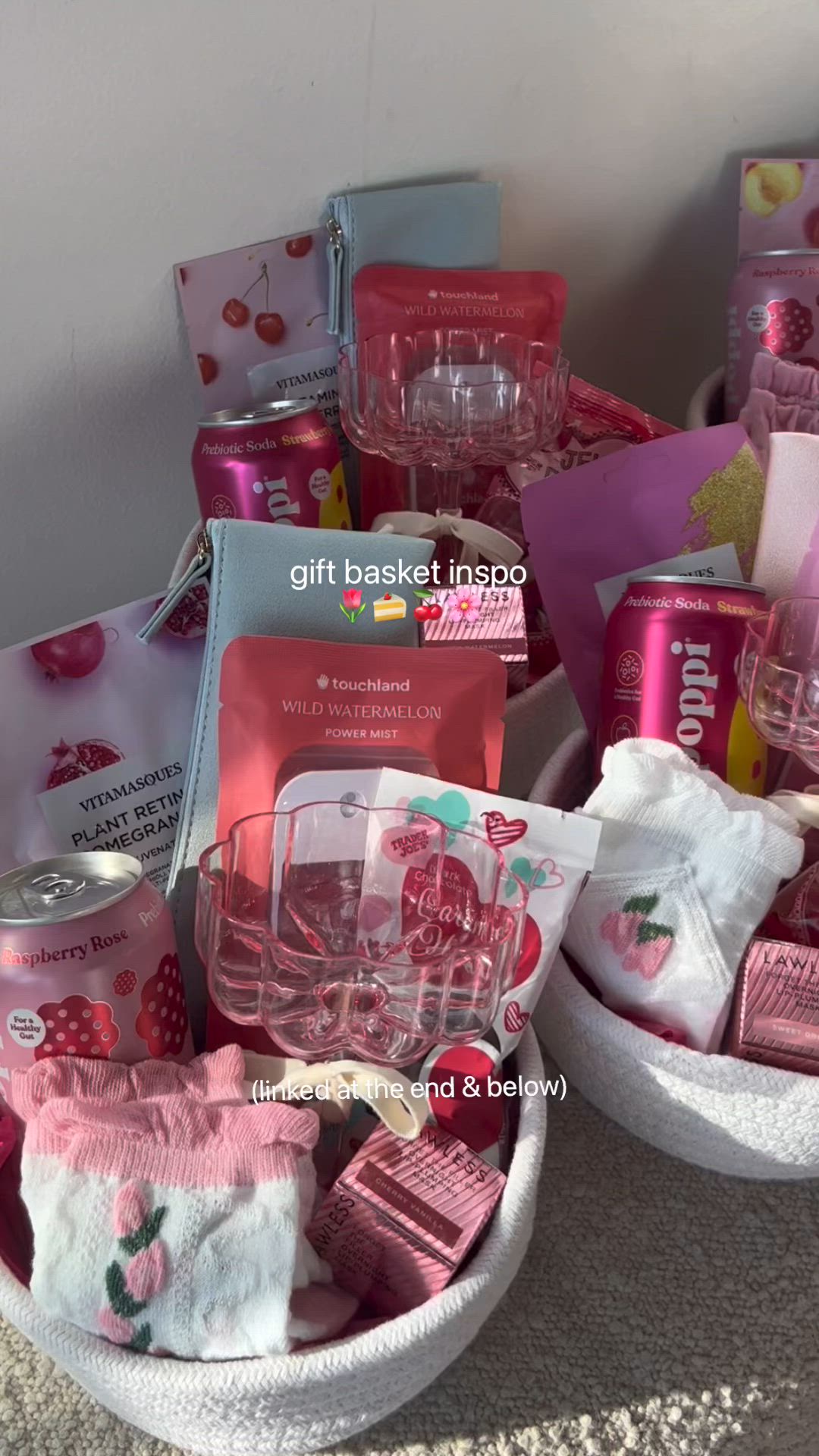 This may contain: the basket is full of pink items for baby's first birthday