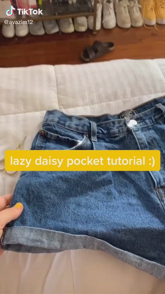 This may contain: someone is holding their jeans in front of the camera and texting lazy daisy pocket tutor