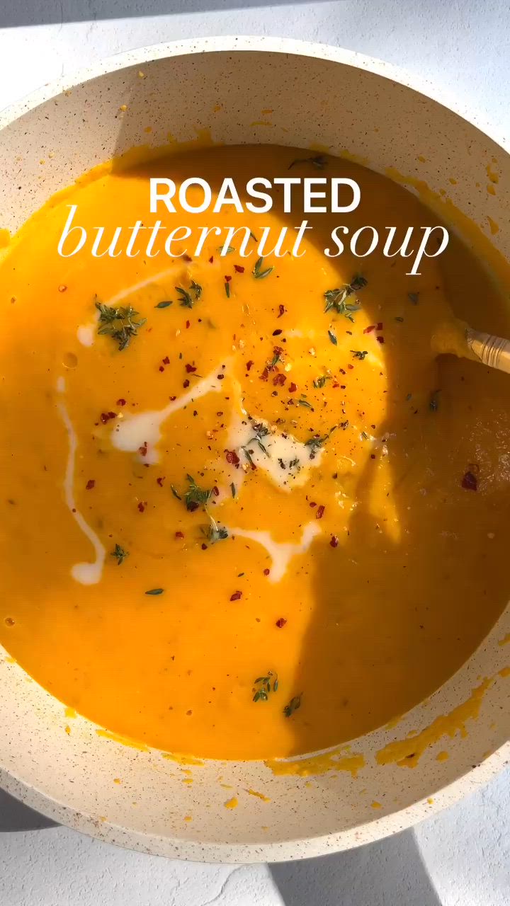 This may contain: a white bowl filled with soup on top of a table