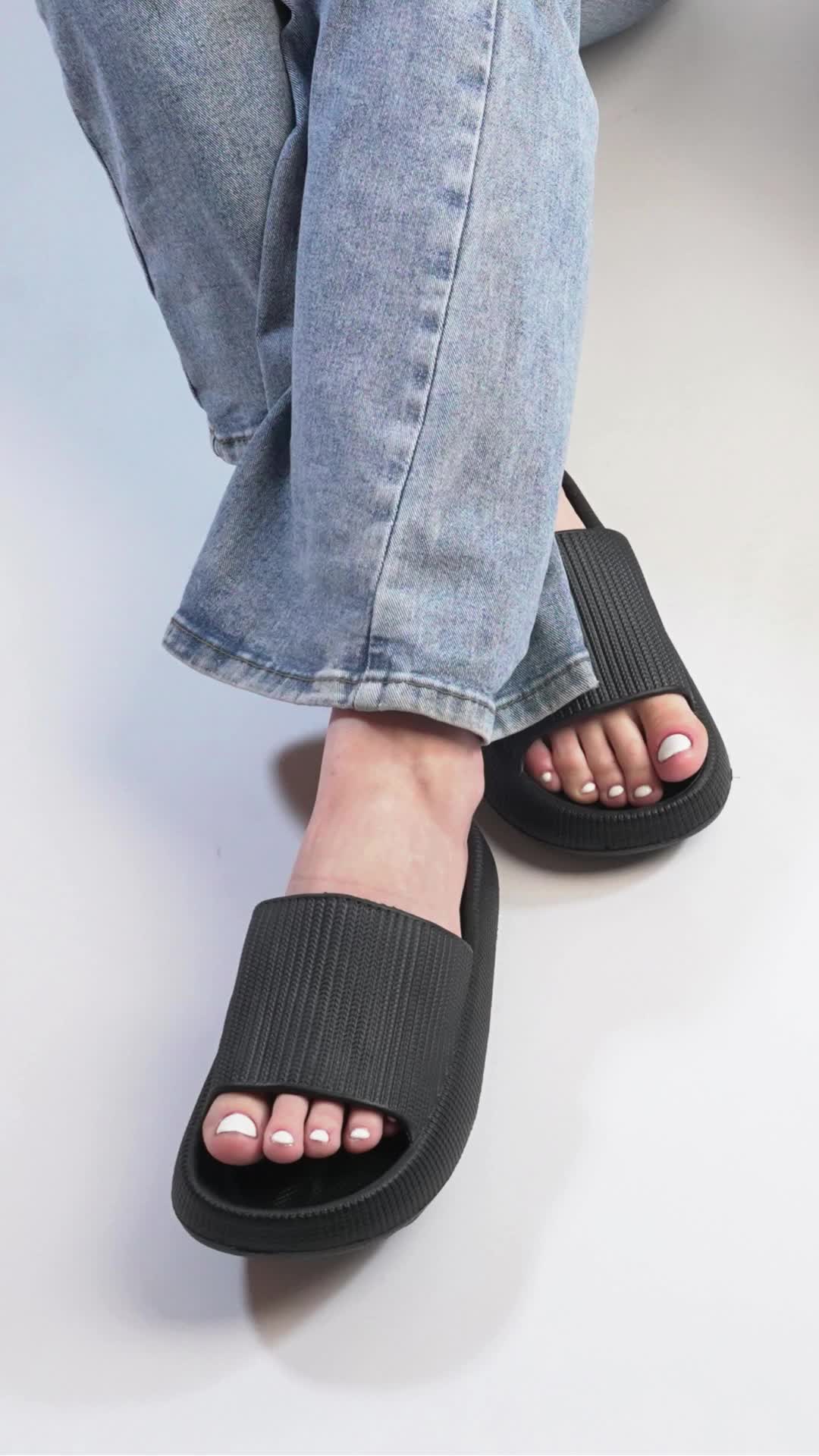 This may contain: a person wearing black sandals and jeans