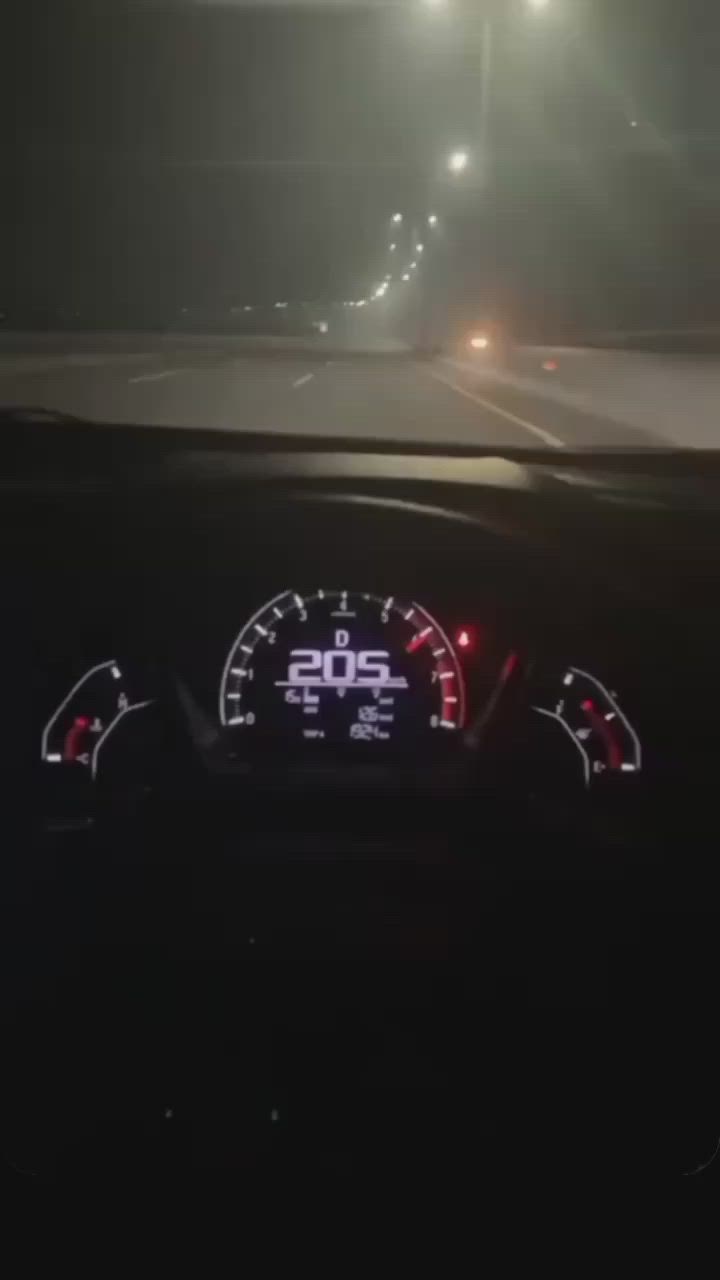 This may contain: the dashboard of a car on a foggy night