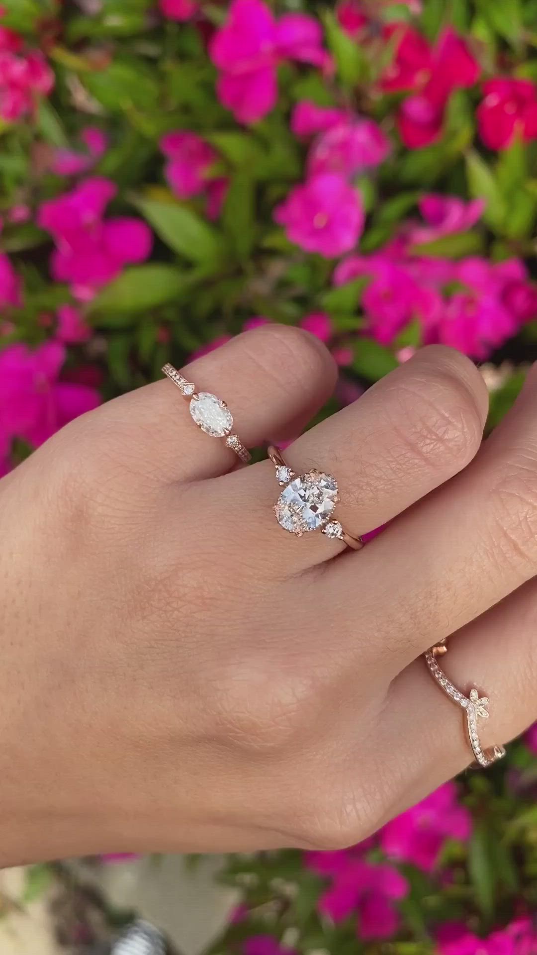 A brilliant, conflict-free oval cut diamond sits atop the band and in this design it is guarded by four handcrafted leaf-like prongs - a subtle tip of the hat to nature and the circle of life. We then sprinkled some diamonds along the ring's gallery to give it extra sparkle and a peek-a-boo halo and two bright white accent diamonds. Approx Band Width (mm): 1.60mm Setting Diamond Quality (side stones): Colorless and VS clarity Approx Setting Total Carat Weight (side stones): 0.14 tcw Approx Production Time: 5-6 weeks Drop-down diamond options represent our recommended grade, which maximizes size for value, while maintaining eye-perfect clarity and giving you a colorless look. For other diamond options, see our Shop Diamonds tab or speak to one of our design consultants. This design can also