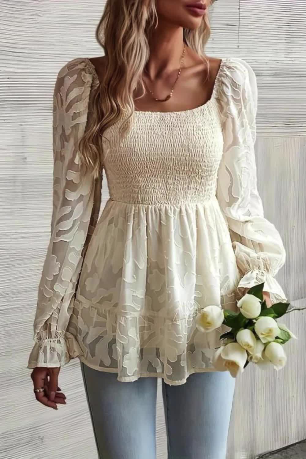 Elevate your spring and summer attire with this elegant blouse, boasting delicate floral embroidery and a charming ruffle hem. Its shirred long puff sleeves add a touch of romance and sophistication to any ensemble. Perfect for those who seek timeless elegance with a hint of whimsy in their wardrobe.