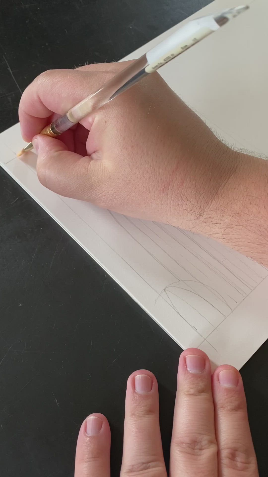 This may contain: a person is drawing on paper with a pencil