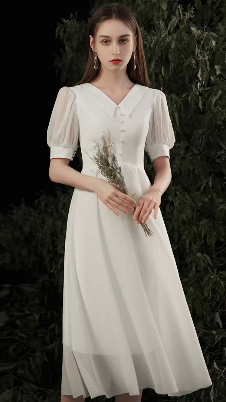 This contains: Retro Tea Length Chiffon Party Dress with Collar Bubble Sleeves