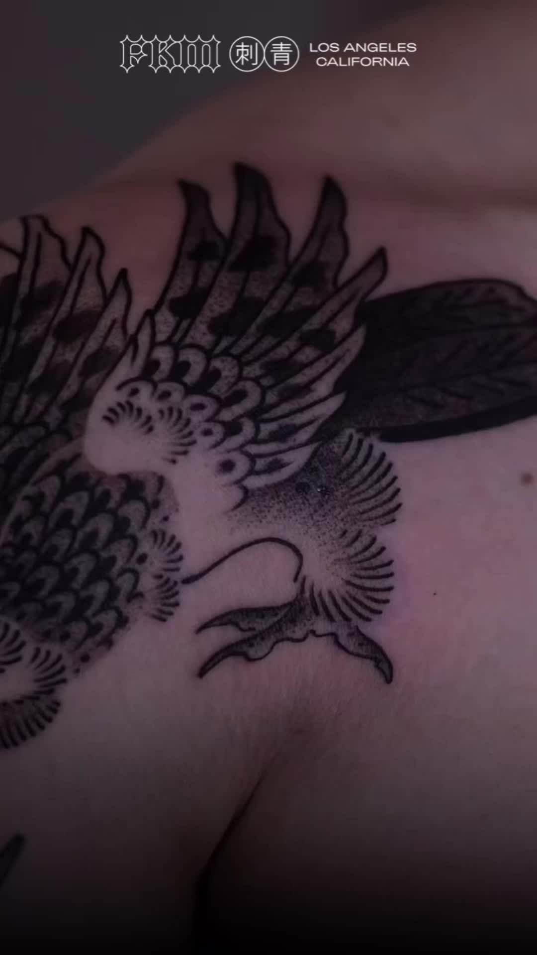 This may contain: an eagle tattoo on the back of a man's chest