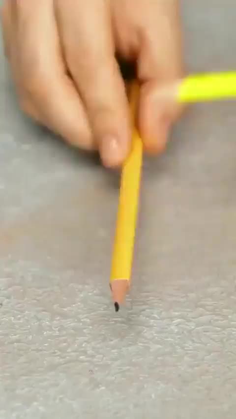 This may contain: a person holding a pencil in their right hand and pointing it at the other end