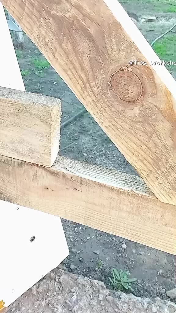 This may contain: a wooden bench sitting on top of a cement ground