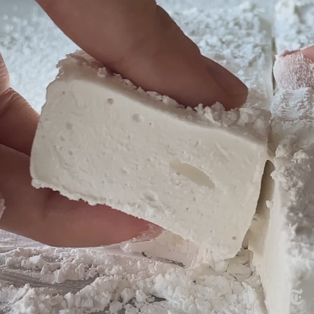 This may contain: a knife is cutting into some food on a plate with powdered sugar and icing