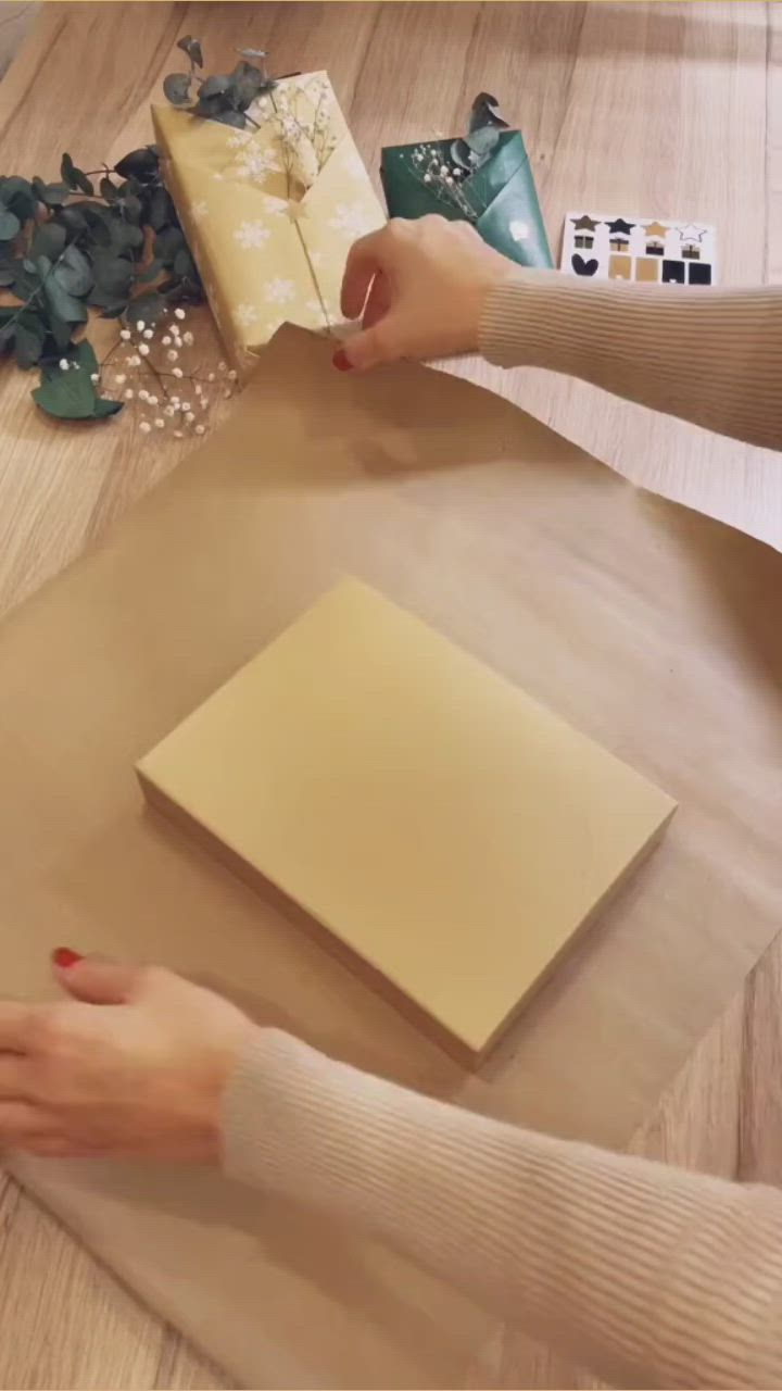 This may contain: someone is wrapping presents on a table with the words diy how to wrap a gift