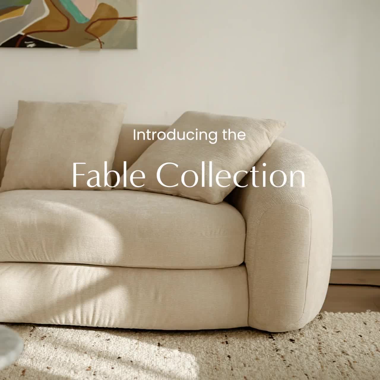 This may contain: a living room scene with focus on the sofa and table in the foreground text reads, announcing the fable collection