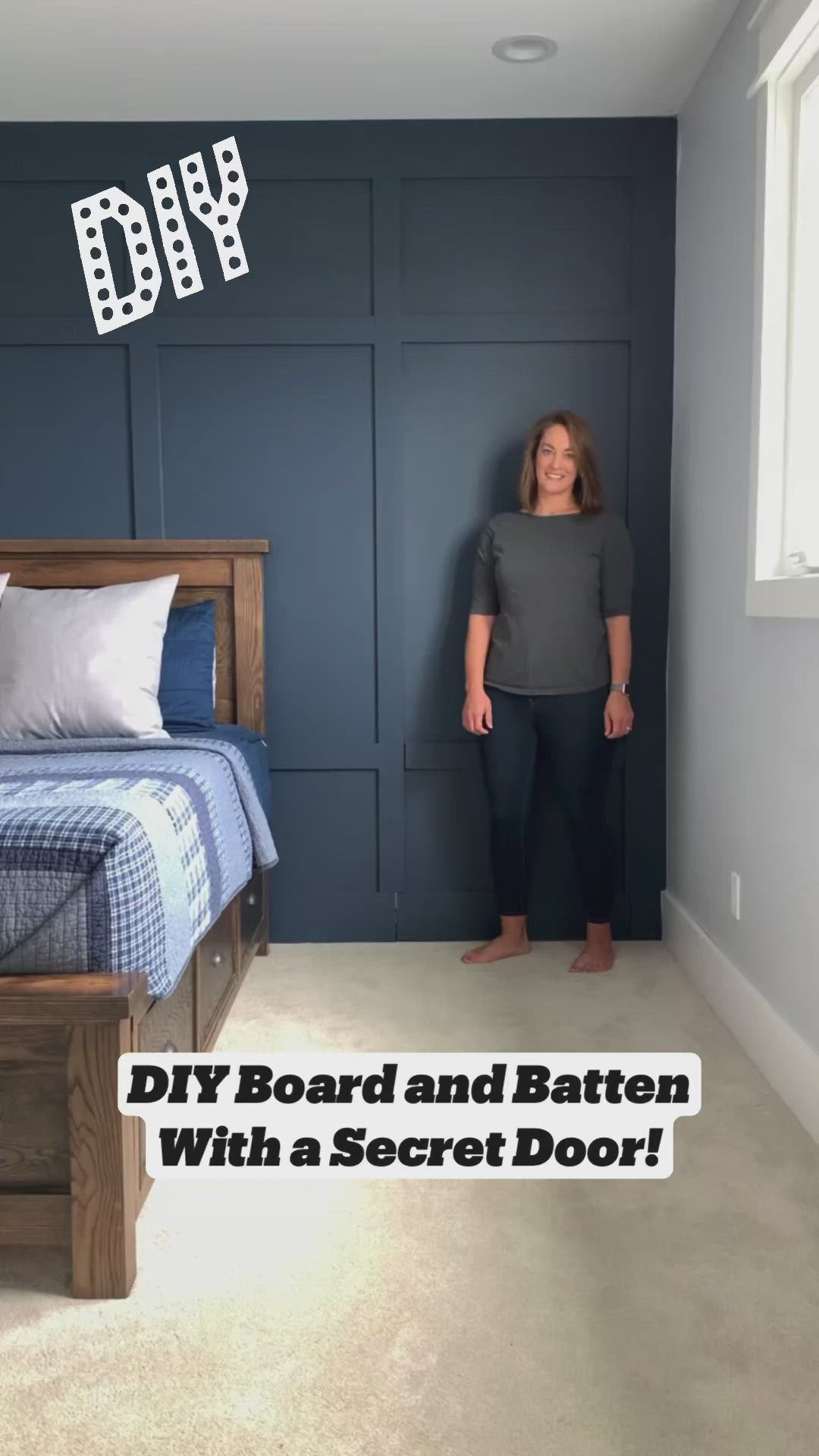 This may contain: a woman standing next to a bed in a room with blue walls and white carpet