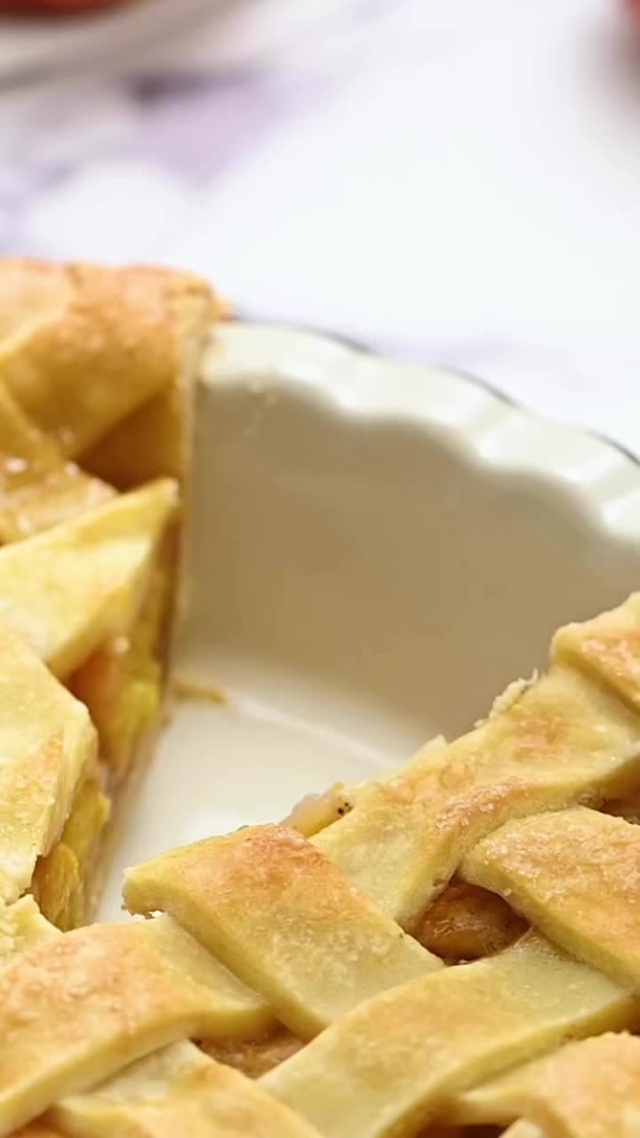 This may contain: an apple pie sitting on top of a marble counter