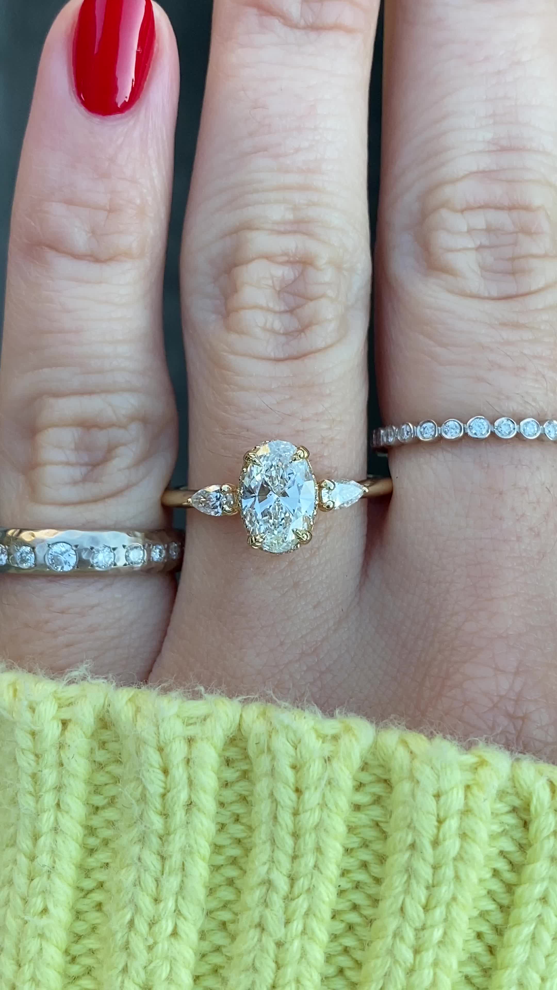 A brilliant, conflict-free oval diamond is guarded by four handcrafted leaf like prongs - a subtle tip of the hat to nature and the circle of life. We then sprinkled some diamonds along the ring's gallery to give it extra sparkle and a peek-a-boo halo and two bright white pear-shaped diamond side stones. Width of band is approximately 1.6mm. Approx Band Width (mm): 1.50mm Setting Diamond Quality (side stones): Colorless and VS clarity Approx Setting Total Carat Weight (side stones): 0.343 tcw Ap