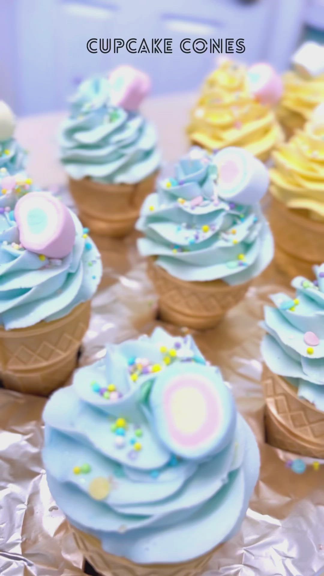 This may contain: cupcakes with yellow frosting and sprinkles are on a table