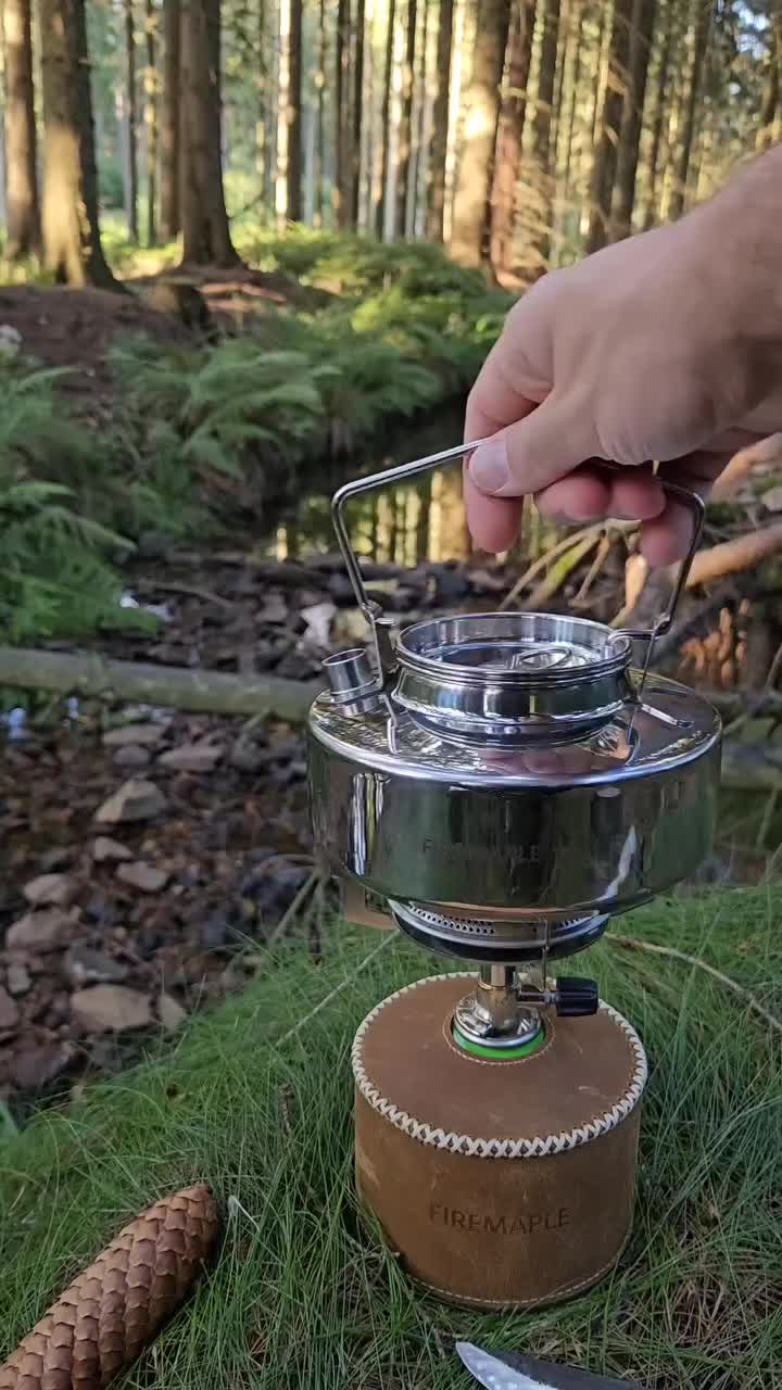 This may contain: a person is pouring something into a bowl with cheese and meats on it in the woods