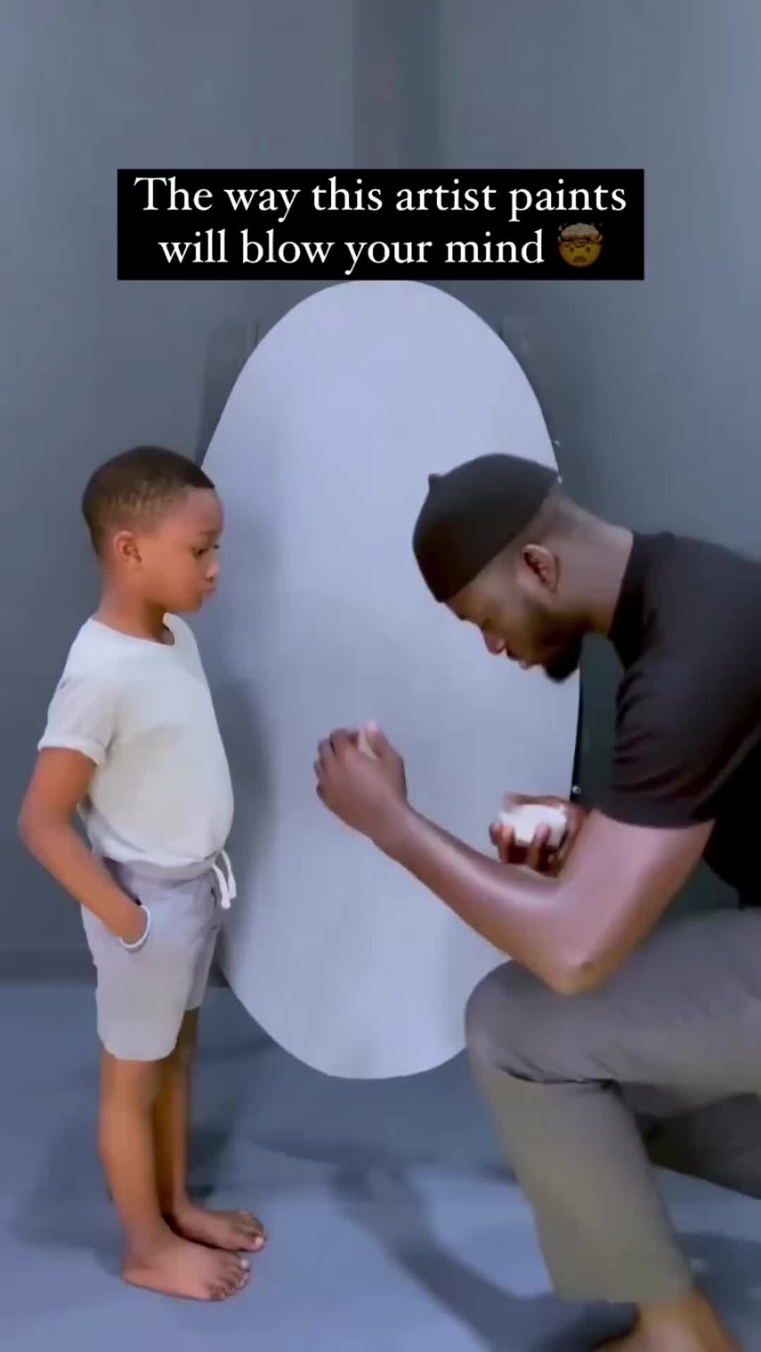 This may contain: a man kneeling down next to a little boy