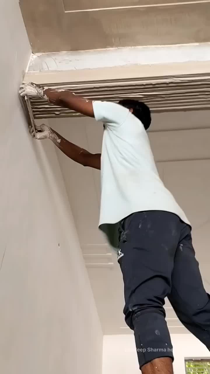 This may contain: a man is painting the ceiling in an empty room