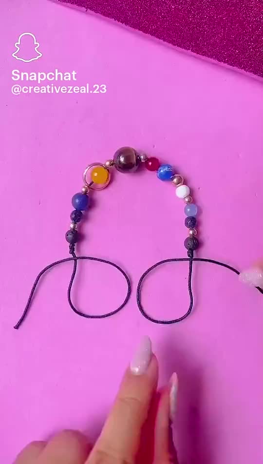 This may contain: someone is making a beaded glasses bracelet with beads