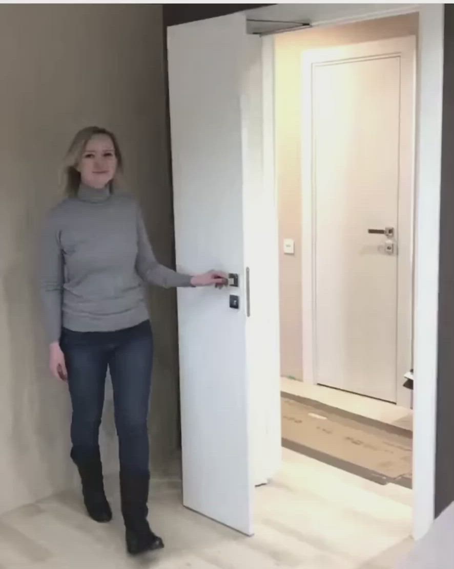 This may contain: a woman is standing in front of an open door