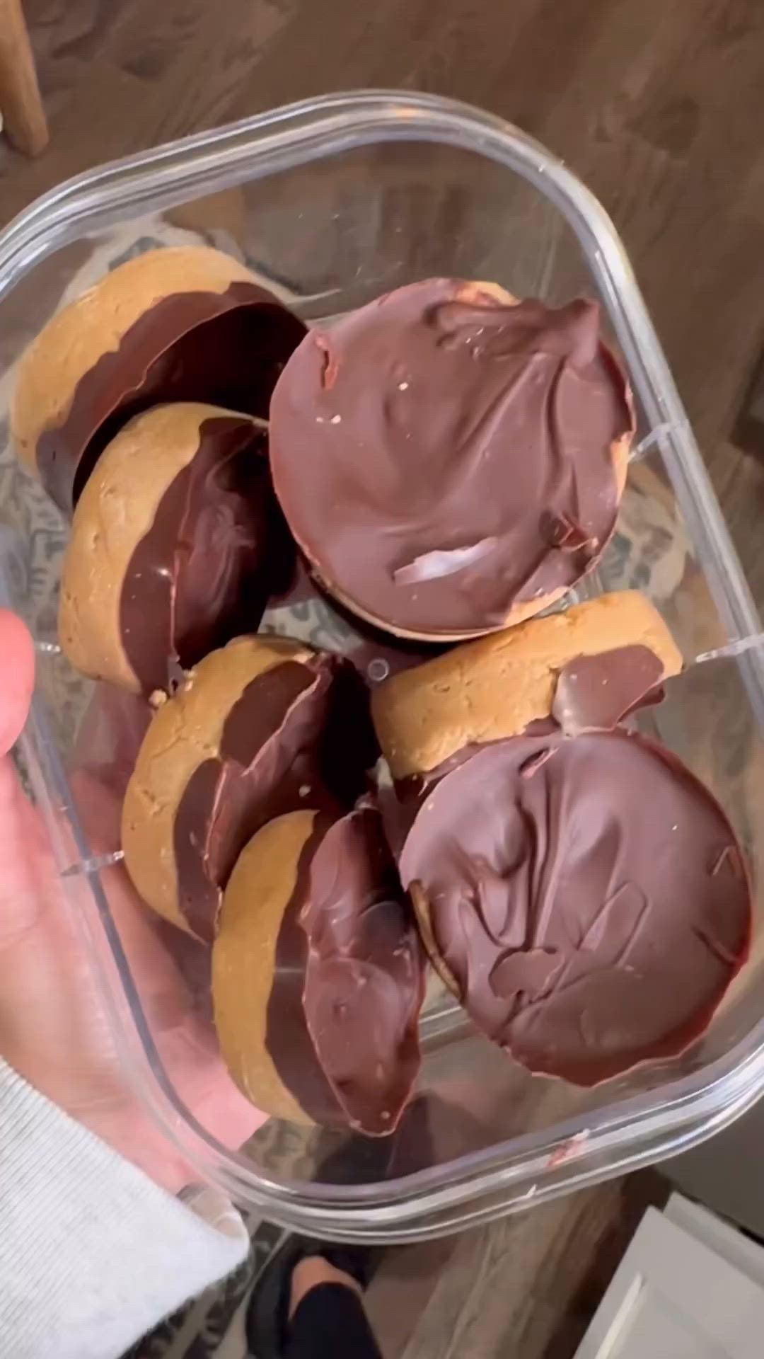 This may contain: a plastic container filled with chocolate covered cookies