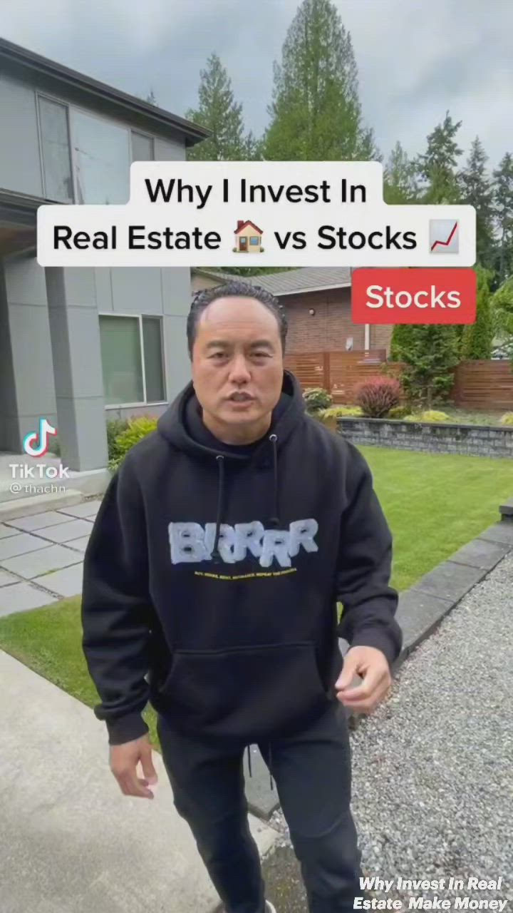 This may contain: a man standing in front of a house wearing a black hoodie that says why i invest in real estate vs stocks