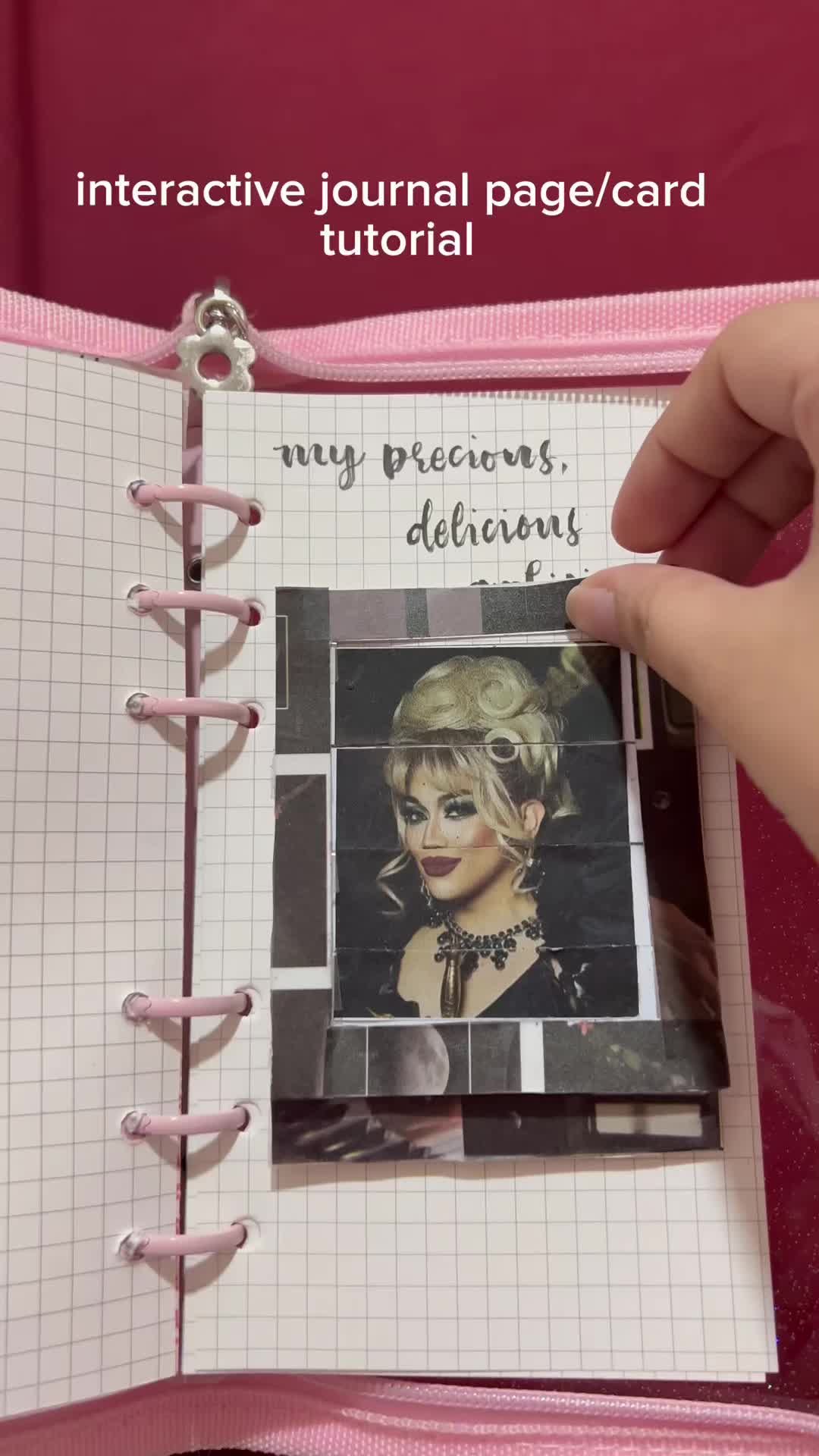 This may contain: a person holding a notebook with an image of a woman's face on it