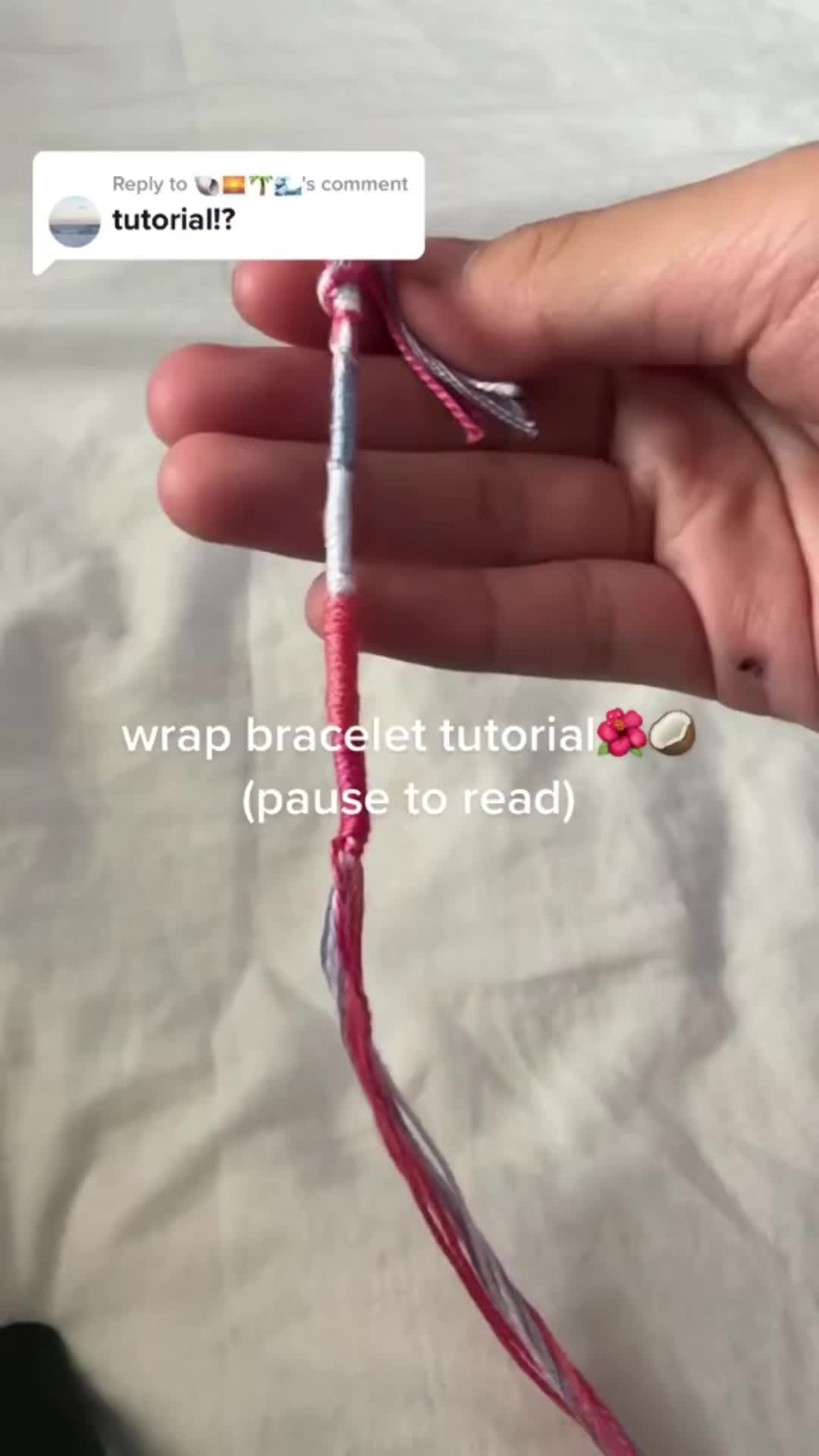 This may contain: a person is holding a piece of yarn in their left hand and the text reads, wrap bracelet victoria pause to read