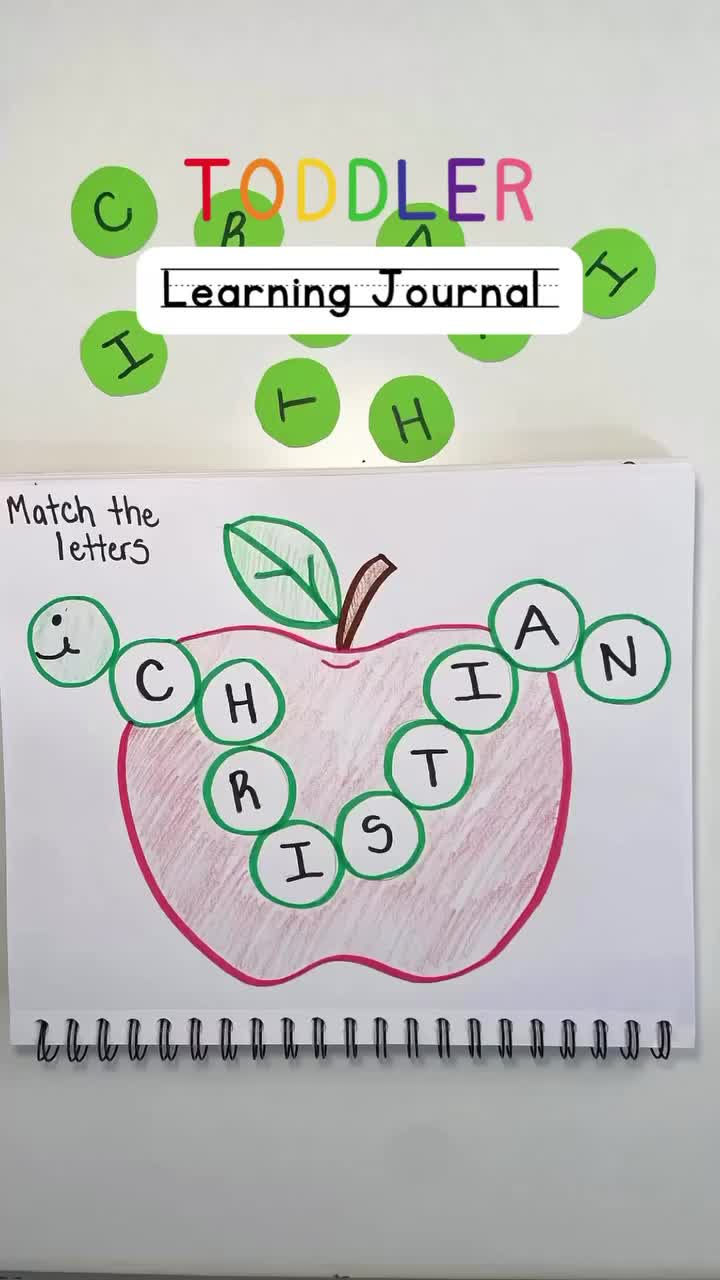 This may contain: a child's hand is drawing an apple with numbers on it