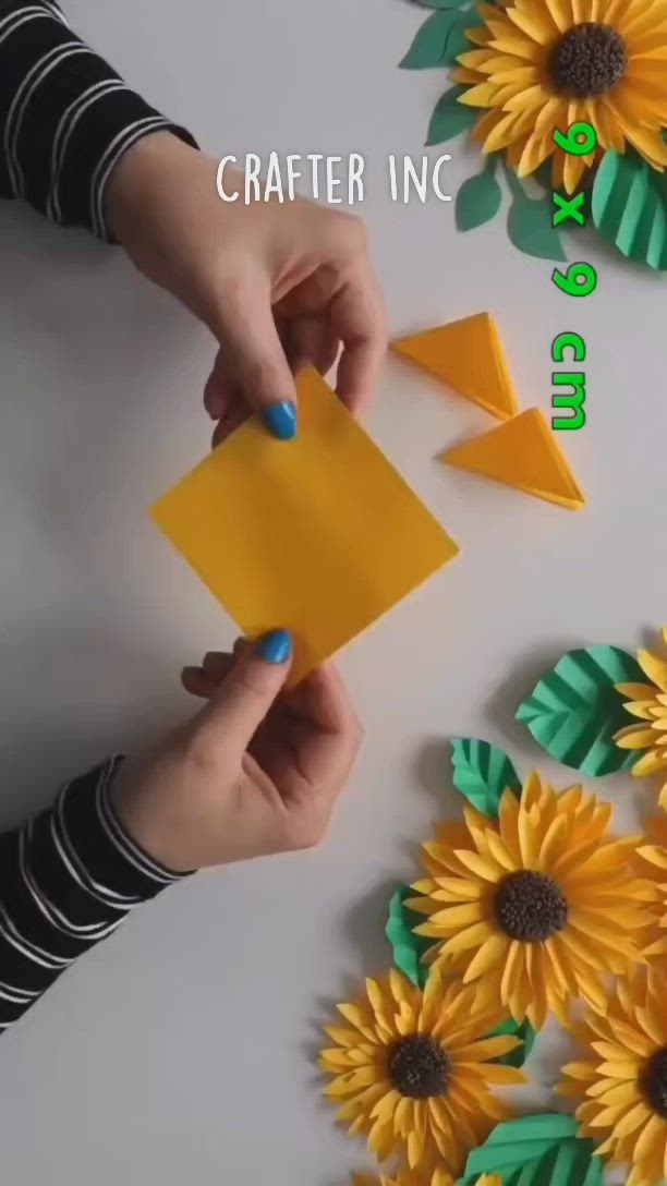 This may contain: someone is making some paper sunflowers out of construction paper