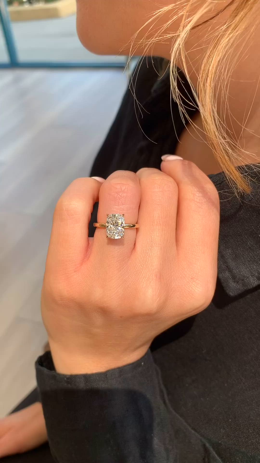 This may contain: a woman's hand with a diamond ring on it