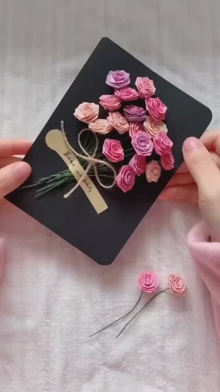 This may contain: a person is holding some pink flowers in their hand and the words roll and fold are above them