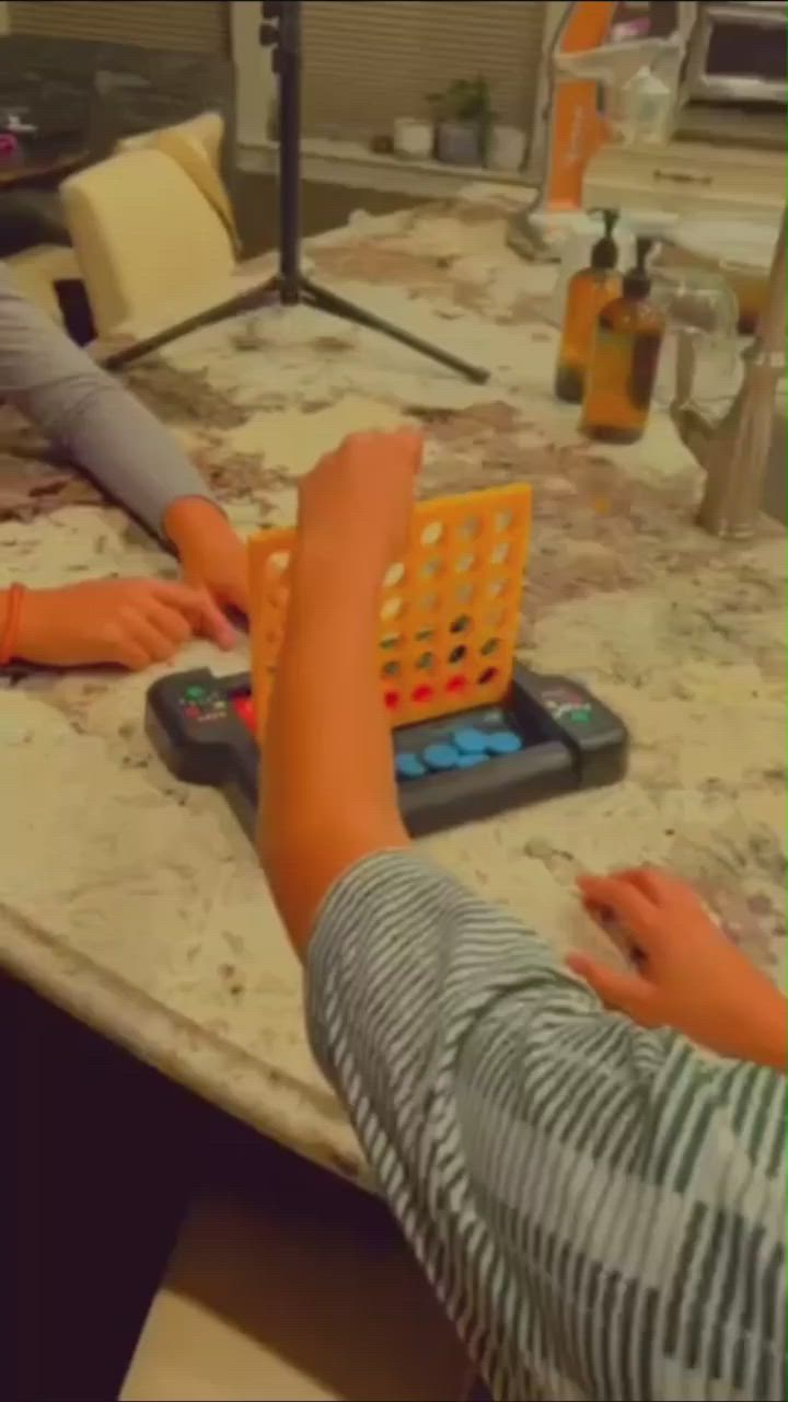 This may contain: two children are playing with an abacus at the table in front of their mother