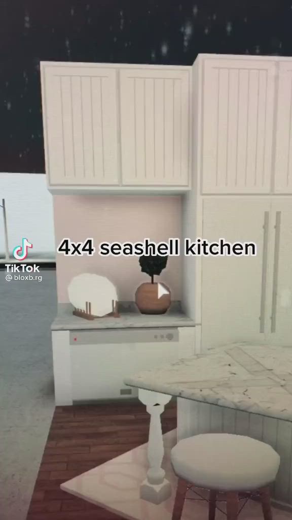 This may contain: a kitchen with white cabinets and an island in the middle is shown at night time