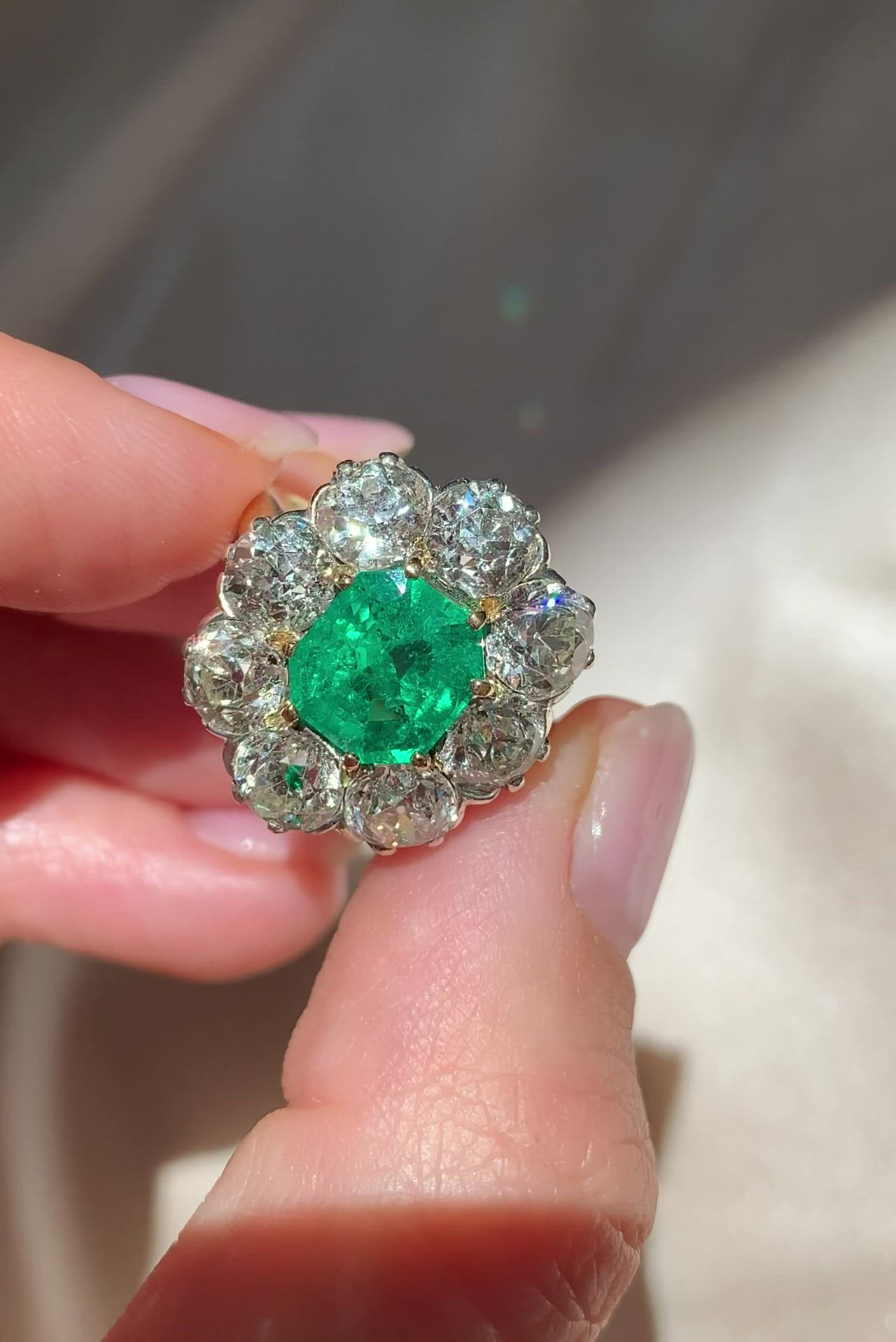 Antique ring centered with an approximately 2.70 carat GIA-certified Columbian emerald with moderate clarity enhancement. Surrounded by old European-cut diamonds of approximately 4.95 carats in total. Each diamond ranges between I and J color and SI2 clarity. Made in platinum and 18k yellow gold. Circa 1889.