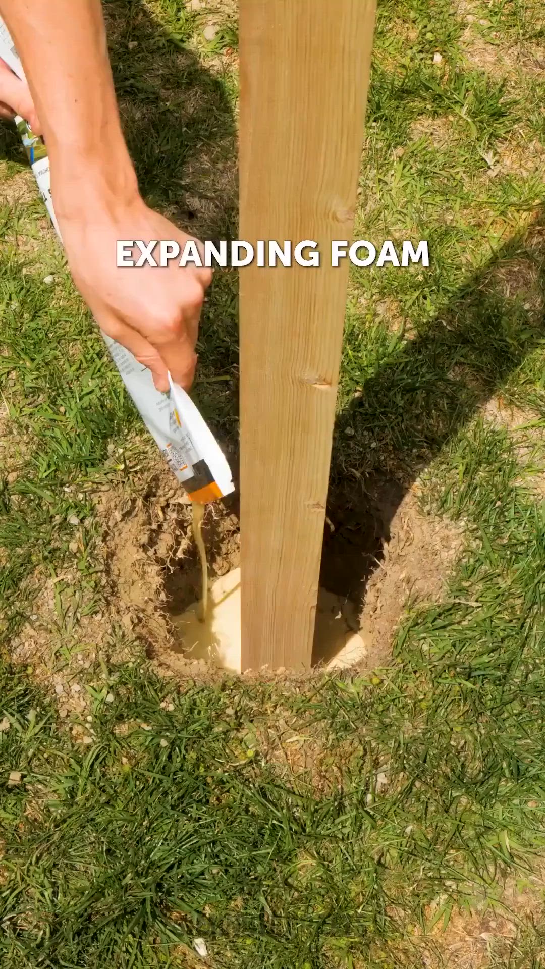 This may contain: a person is using a knife to cut through a hole in the ground with grass