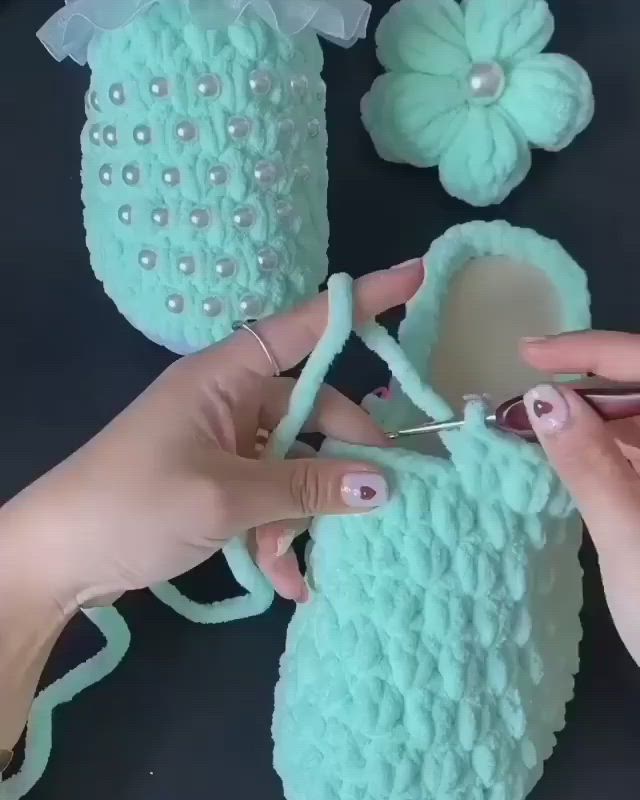 This may contain: someone is crocheting something with scissors and yarn