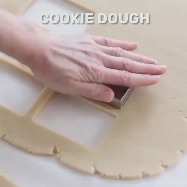 This may contain: a person is kneading dough on top of a cookie sheet with the word cookie dough in front of them