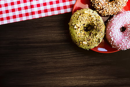 three donuts on red plate