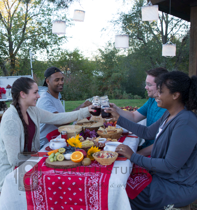 four friends toasting an outdoor chili party