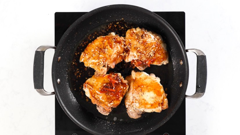 add sauce to thighs in pan