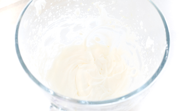 homemade whipped cream in clear mixing bowl