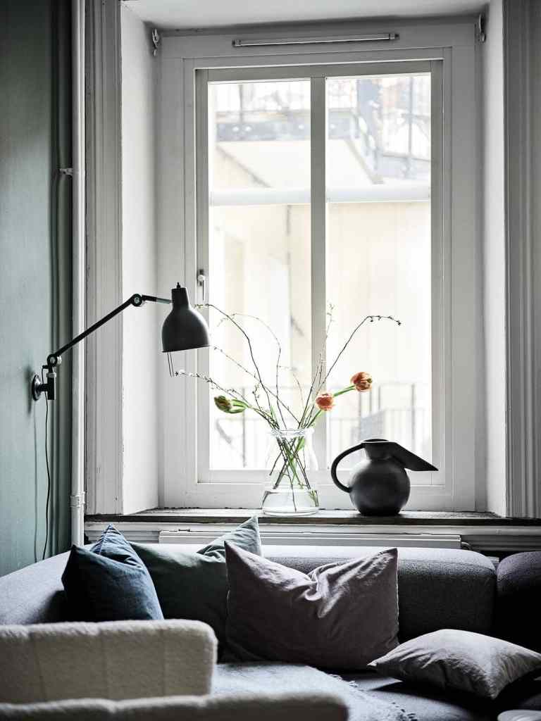 A dark green wall combined with white window frames