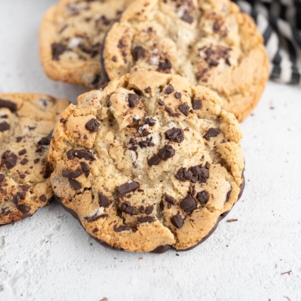 Close up of 4 jacques torres chocolate chip cookies on a counter.