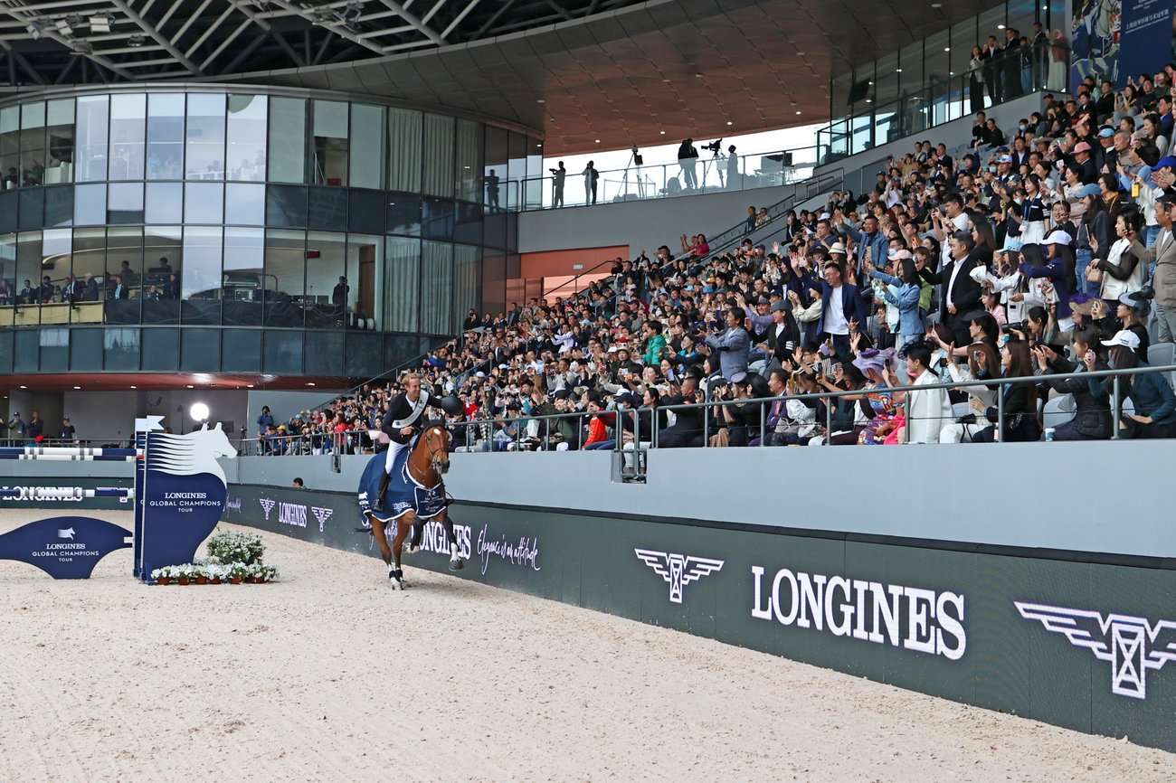 Gilles Thomas riding a victory lap on Luna van het Dennehof in Shanghai