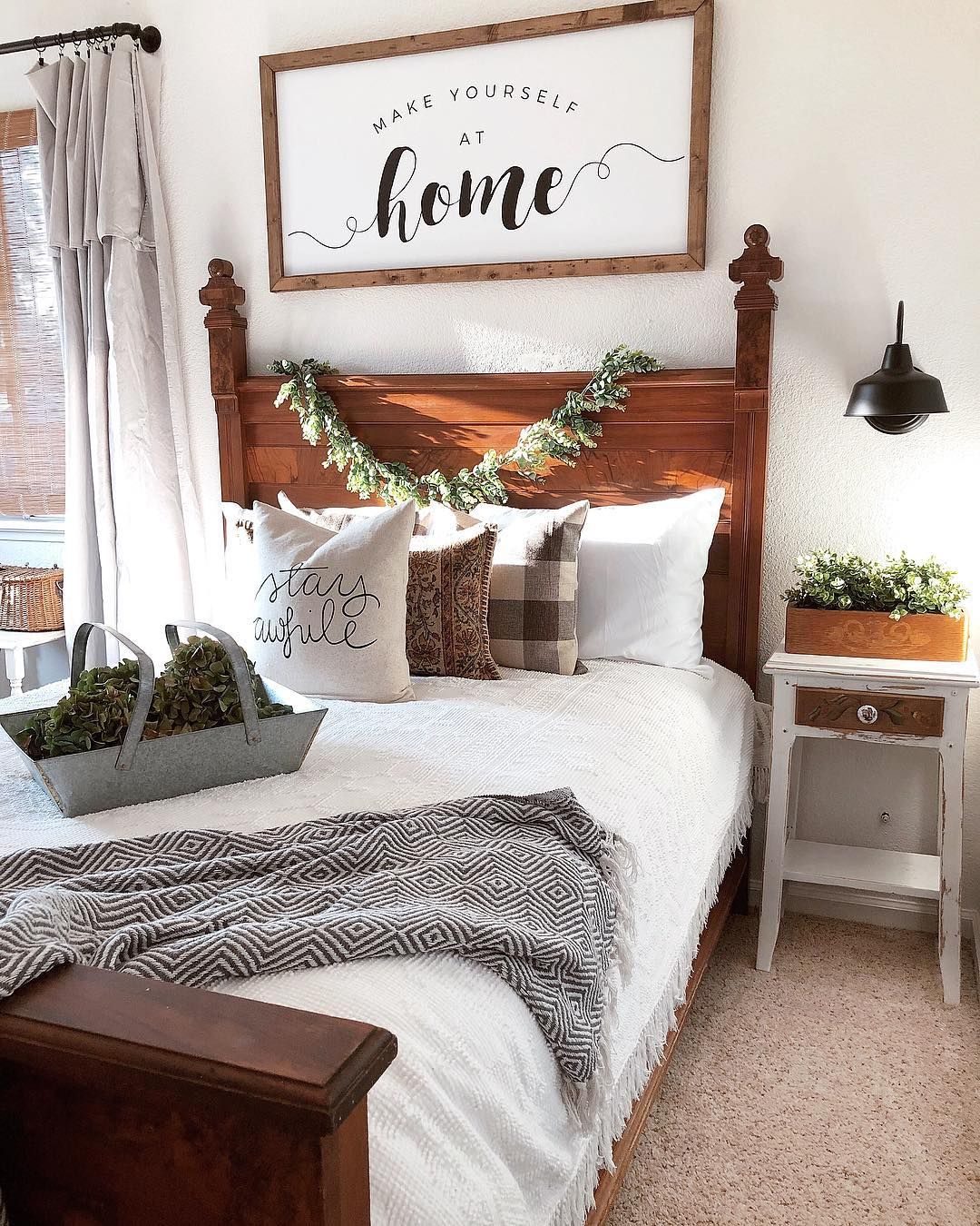 Farmhouse guestroom with cozy wood bed and nightstand