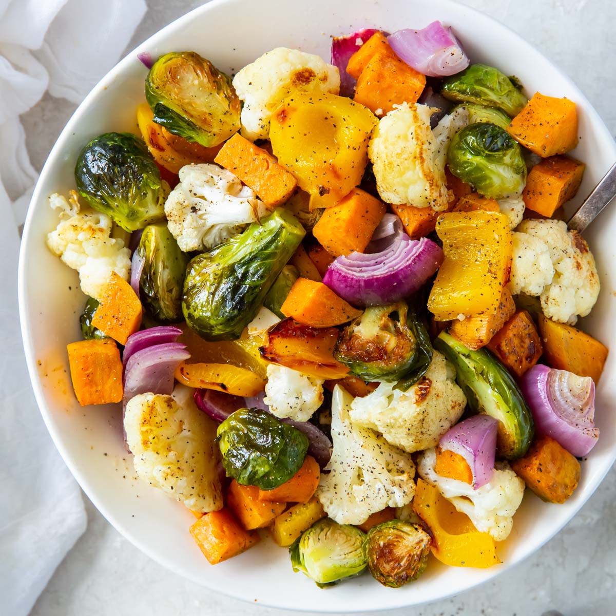 oven roasted vegetables in white serving bowl