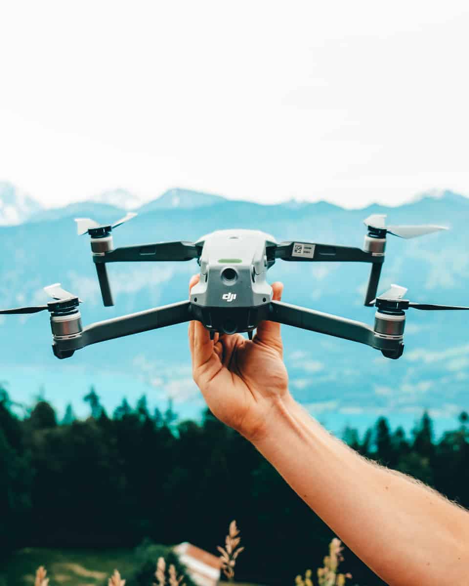 Best drone for travel, DJI Mavic 2 Pro, held out above the Swiss alps