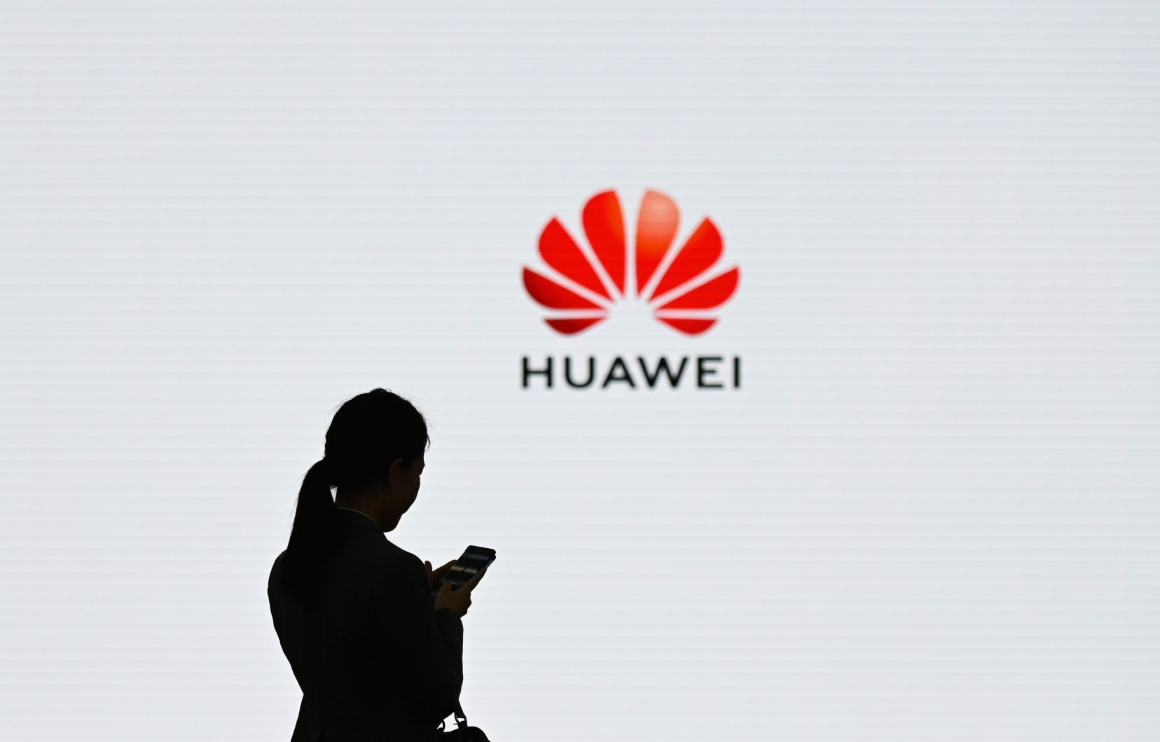 Women standing next to Huawei logo. (COURTESSY PHOTO)