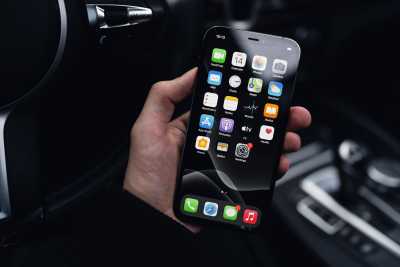 Man Holding a Smartphone in a Car Free Photo